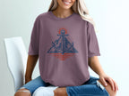 Purple t-shirt with anchor, mountain, and sun graphic.