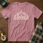 Pink t-shirt with a cream outline graphic of mountains and pine trees.