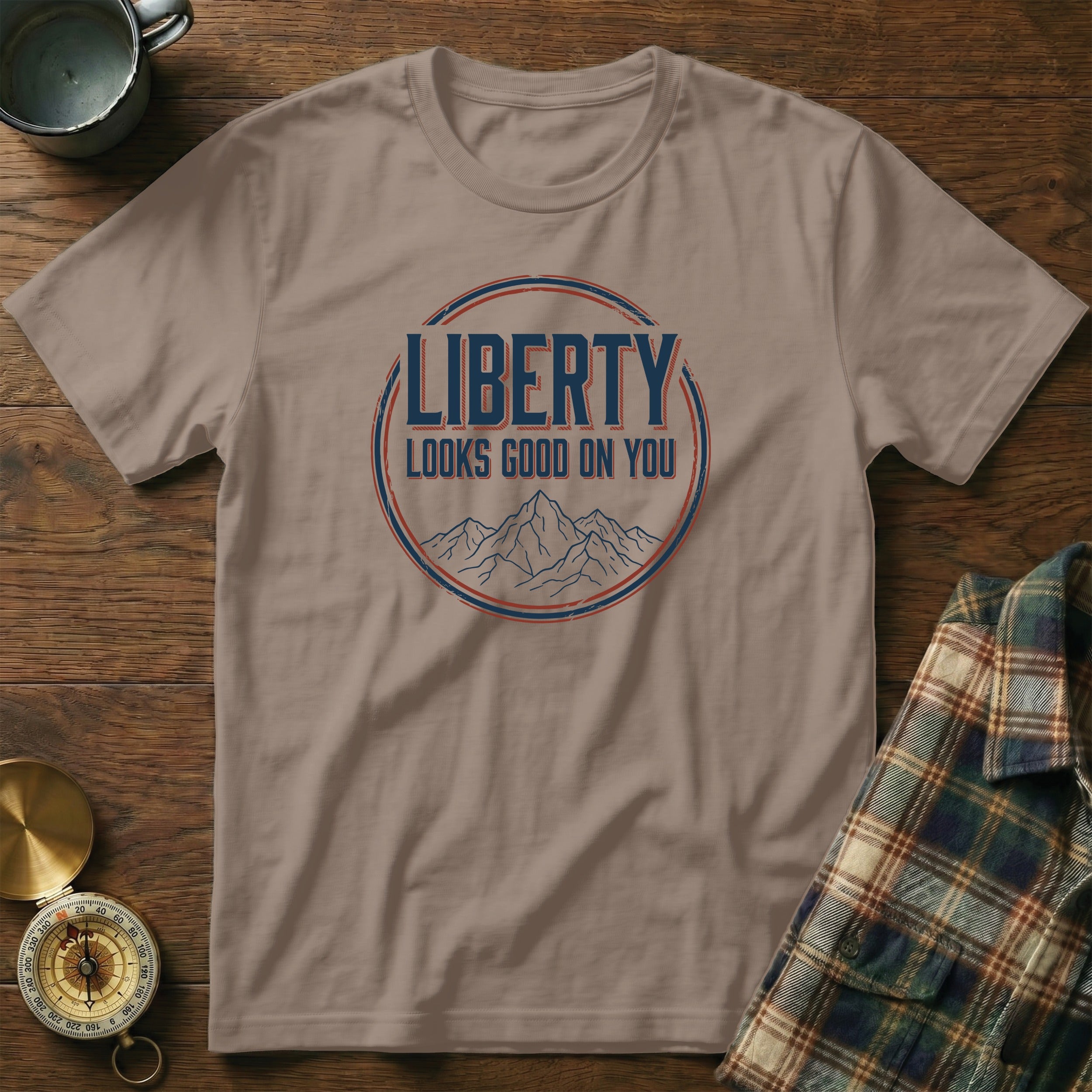 Brown t-shirt with "Liberty Looks Good On You" text and mountain graphic.