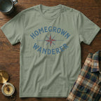 Khaki t-shirt with blue "HOMEGROWN WANDERER" text and compass design.