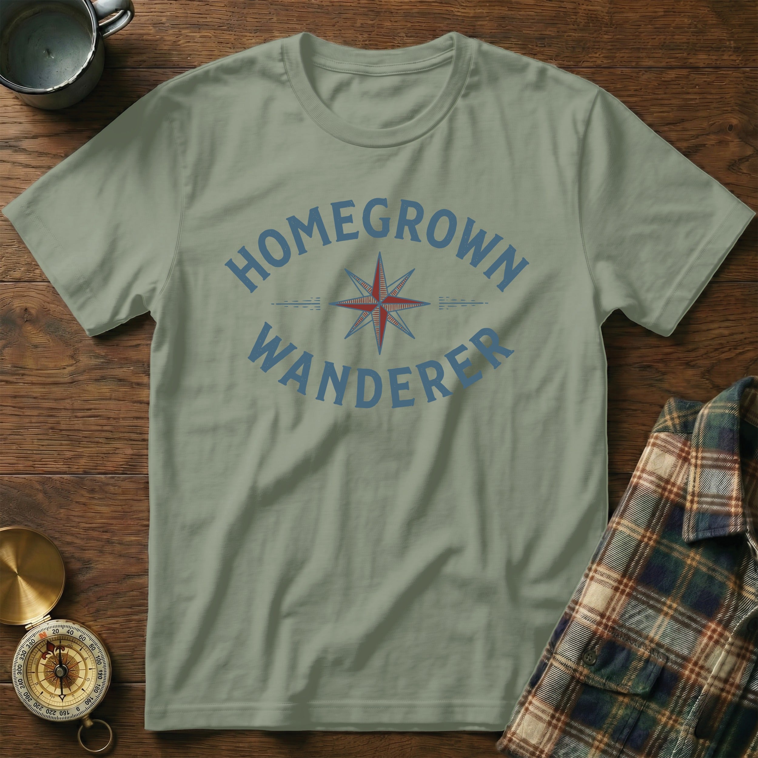 Khaki t-shirt with blue "HOMEGROWN WANDERER" text and compass design.