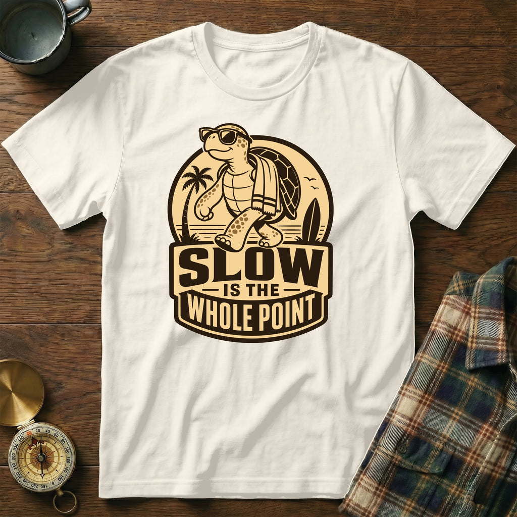 White t-shirt with a graphic of a tortoise walking on a beach, saying "SLOW IS THE WHOLE POINT".