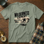 Green t-shirt with "WILDERNESS EXPERT" text and beach chair graphic.