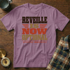 A mauve short-sleeve t-shirt with brown, gold, and red text reading "REVEILLE IS NOW OPTIONAL EFFECTIVE IMMEDIATELY".