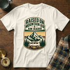 White t-shirt graphic with text "Raised On Mountain Air & AM Radio" and a retro van.