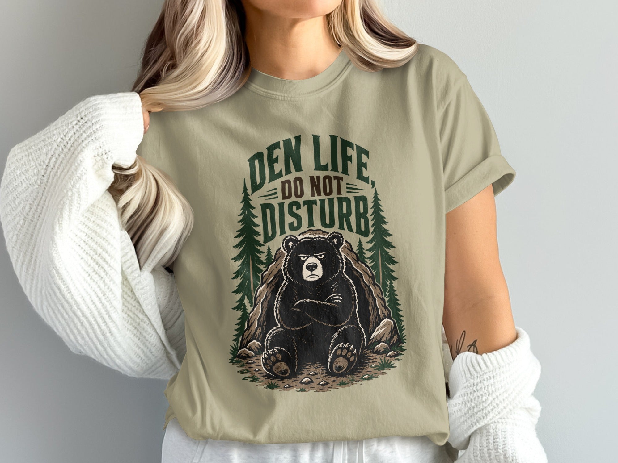 T-shirt graphic with a grumpy bear in a den and "Den Life Do Not Disturb" text.