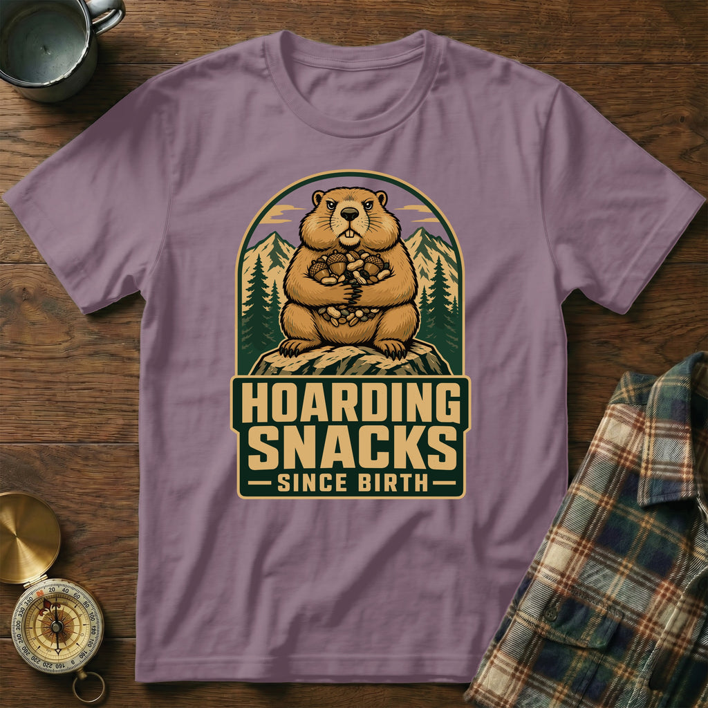 Groundhog hoarding snacks with mountains and trees behind it.