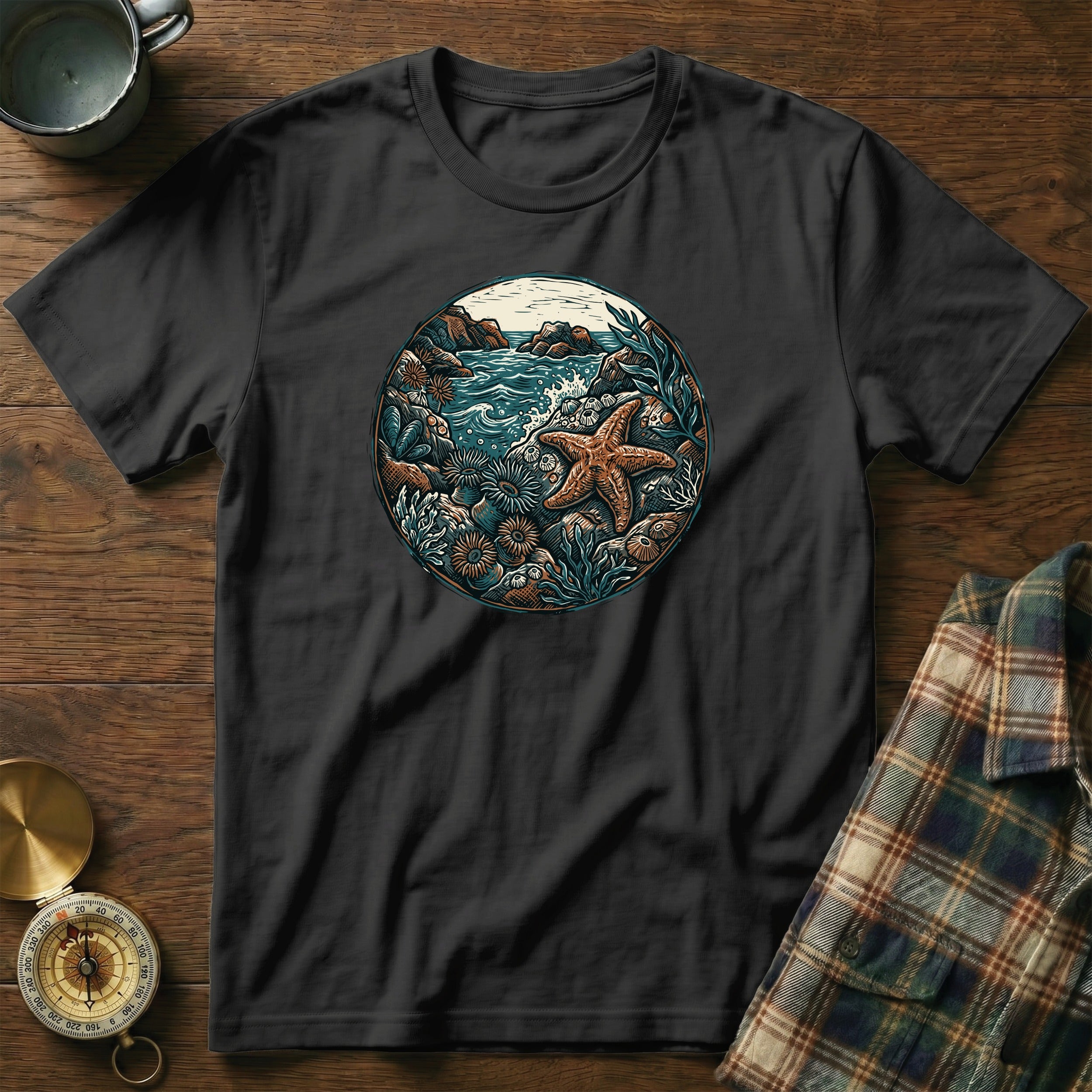 Black t-shirt with circular ocean nature scene featuring starfish and coral.