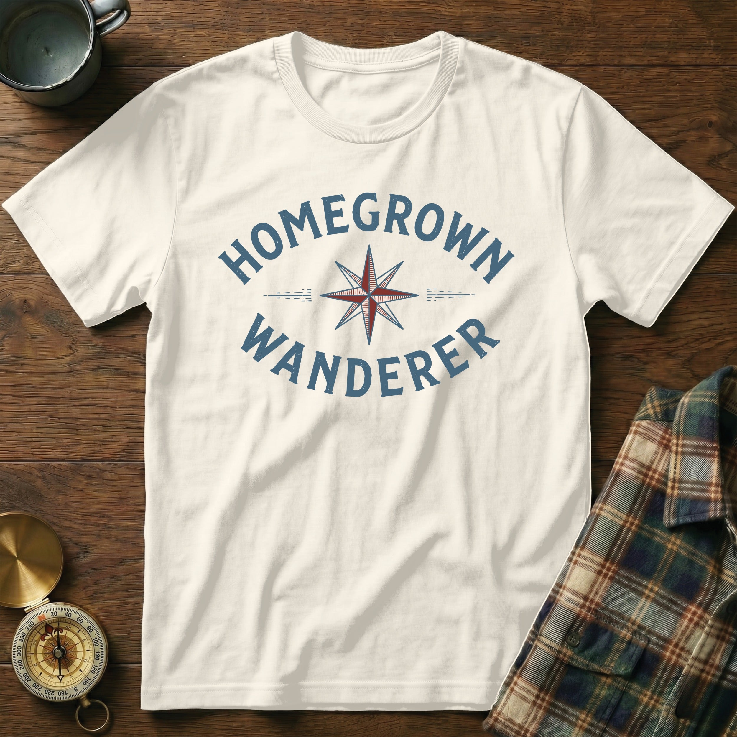 White t-shirt with "HOMEGROWN WANDERER" text and compass graphic.