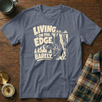Grey t-shirt with "Living on the edge, barely" graphic featuring a goat.