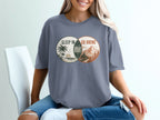 T-shirt with graphic of two overlapping circles: "Sleep In" with beach and "Go Hiking" with mountains.