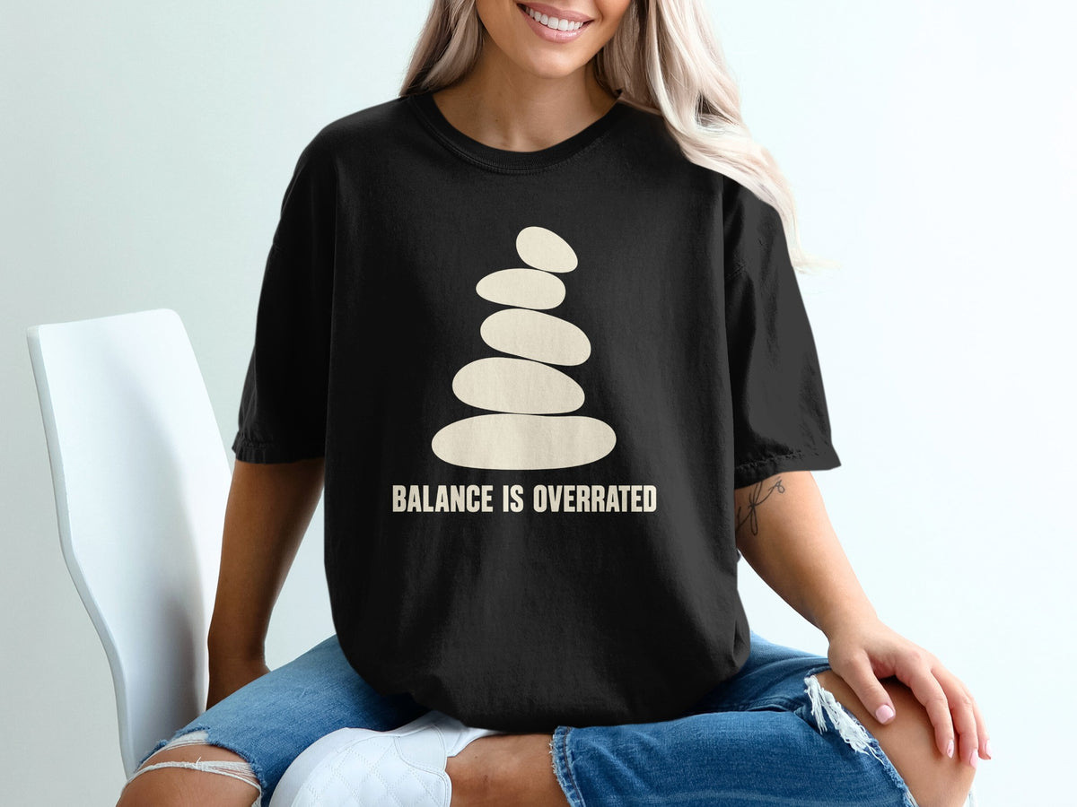 Black t-shirt with stacked stones graphic and text "BALANCE IS OVERRATED."