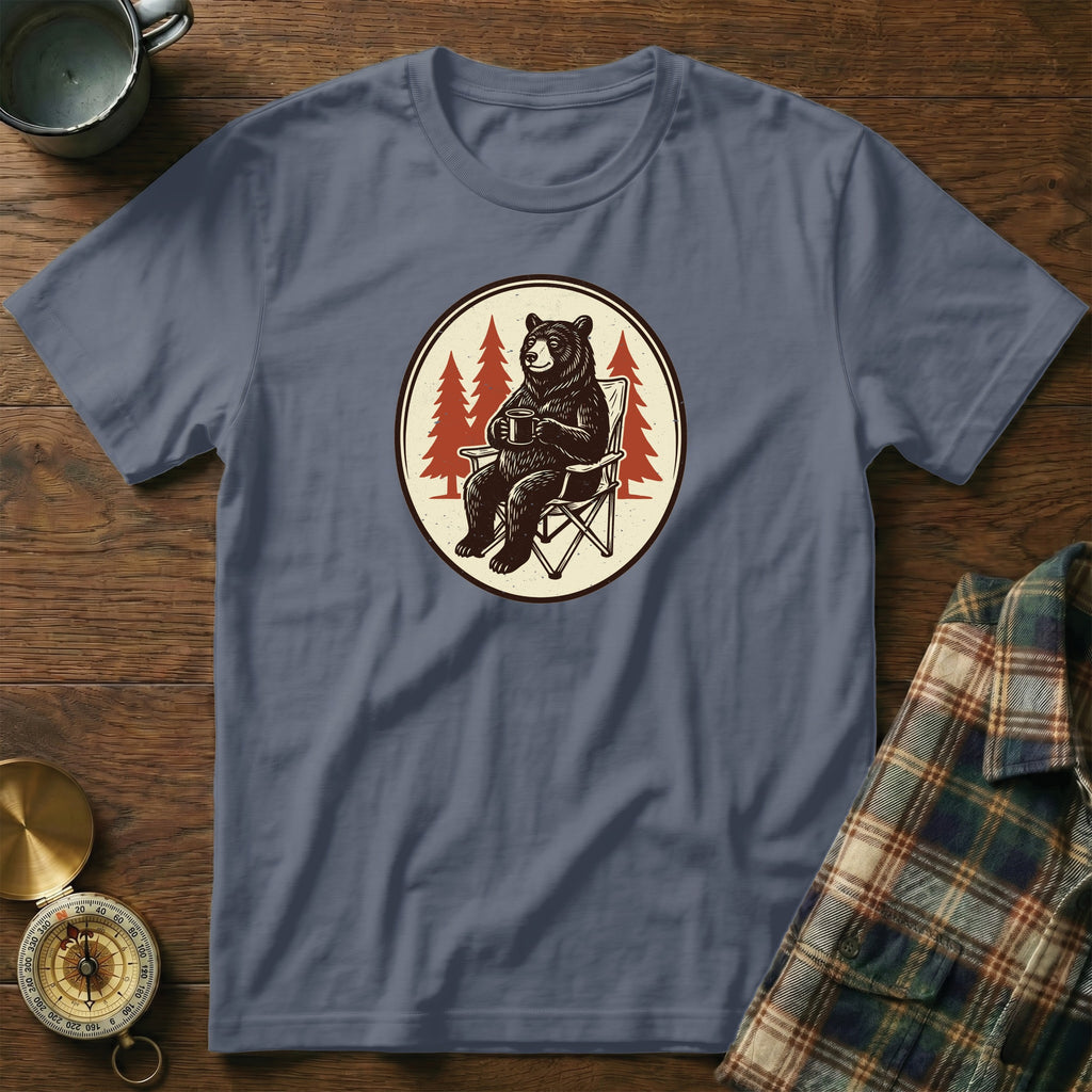 T-shirt graphic of a bear sitting in a chair with a mug of coffee.