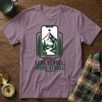 Purple t-shirt with "LESS SCROLL. MORE STROLL." text and nature graphic.