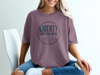 Purplish t-shirt with circle graphic and text "Liberty Looks Good On You".