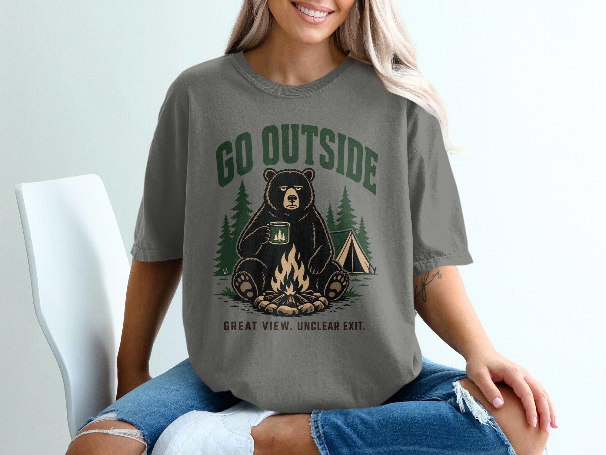 Bear with mug by campfire and tent, text says "GO OUTSIDE GREAT VIEW. UNCLEAR EXIT."