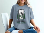T-shirt with mountains in phone graphic and text "LESS SCROLL. MORE STROLL."