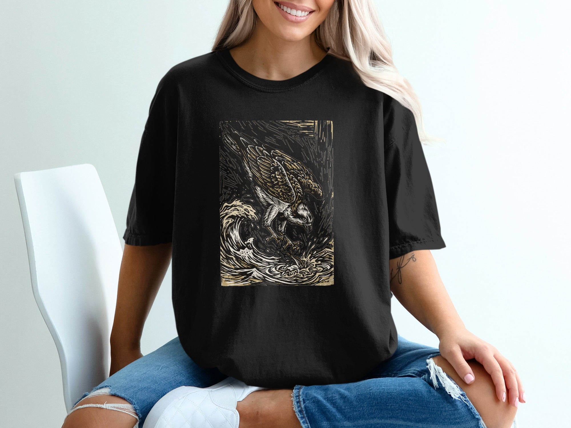 Black t-shirt with a woodcut-style eagle illustration in waves.