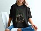 Black t-shirt graphic with bear at den entrance, text reads "Den Life Do Not Disturb".