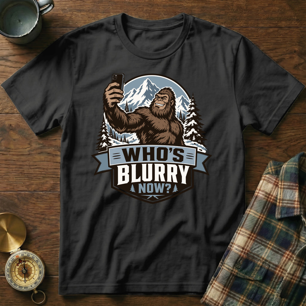 Bigfoot taking a selfie with mountains and text "Who's Blurry Now?"