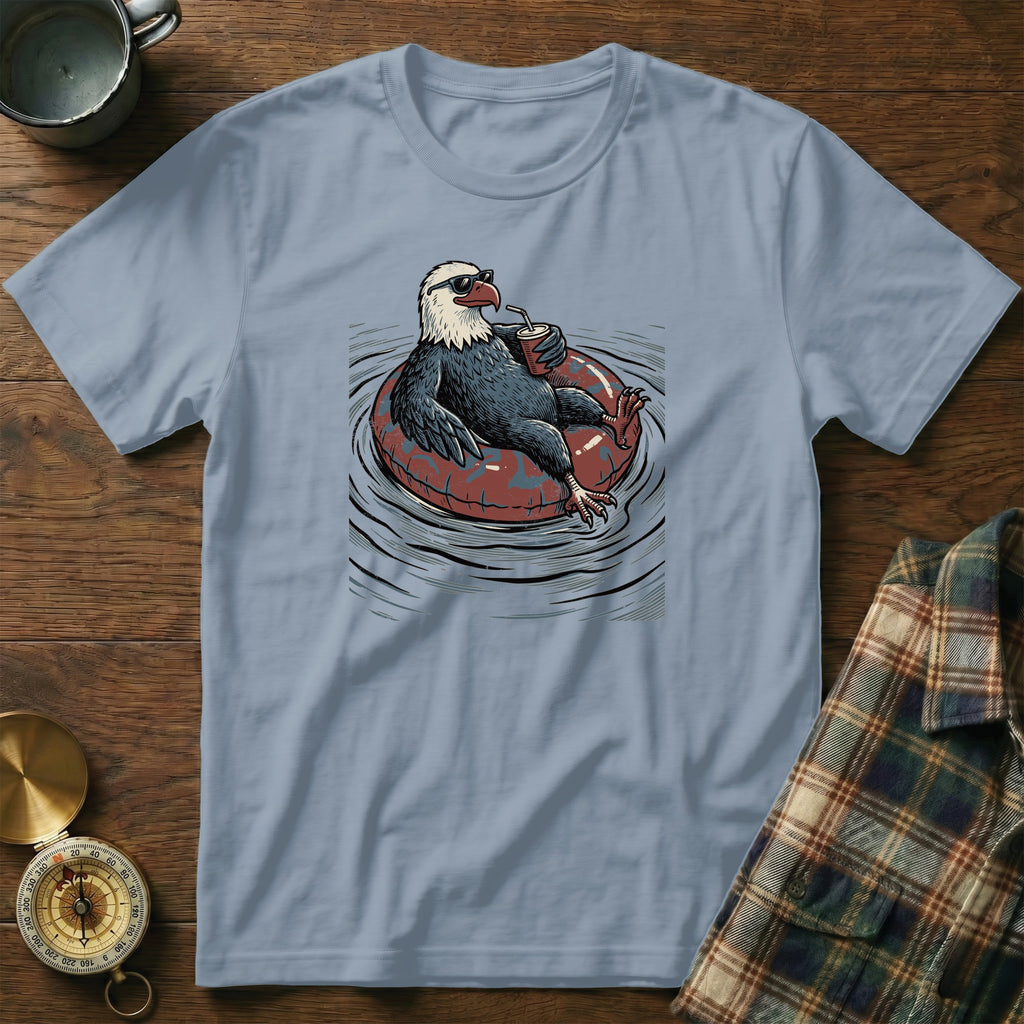 Eagle wearing sunglasses relaxes on an inner tube, holding a drink.