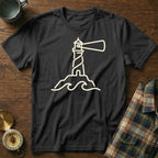 Black t-shirt with a cream line art of a lighthouse on a rock with waves.