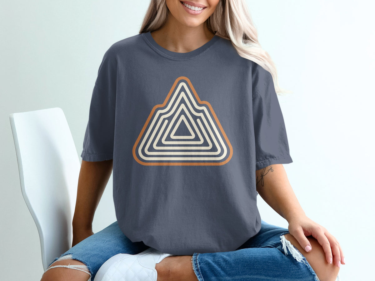 Slate gray t-shirt with a geometric mountain design in orange and cream.