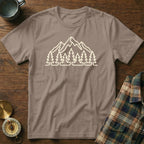 Brown t-shirt with white outline graphic of mountains and pine trees.