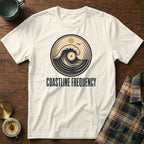 Cream t-shirt with circular wave and record graphic, text "COASTLINE FREQUENCY".