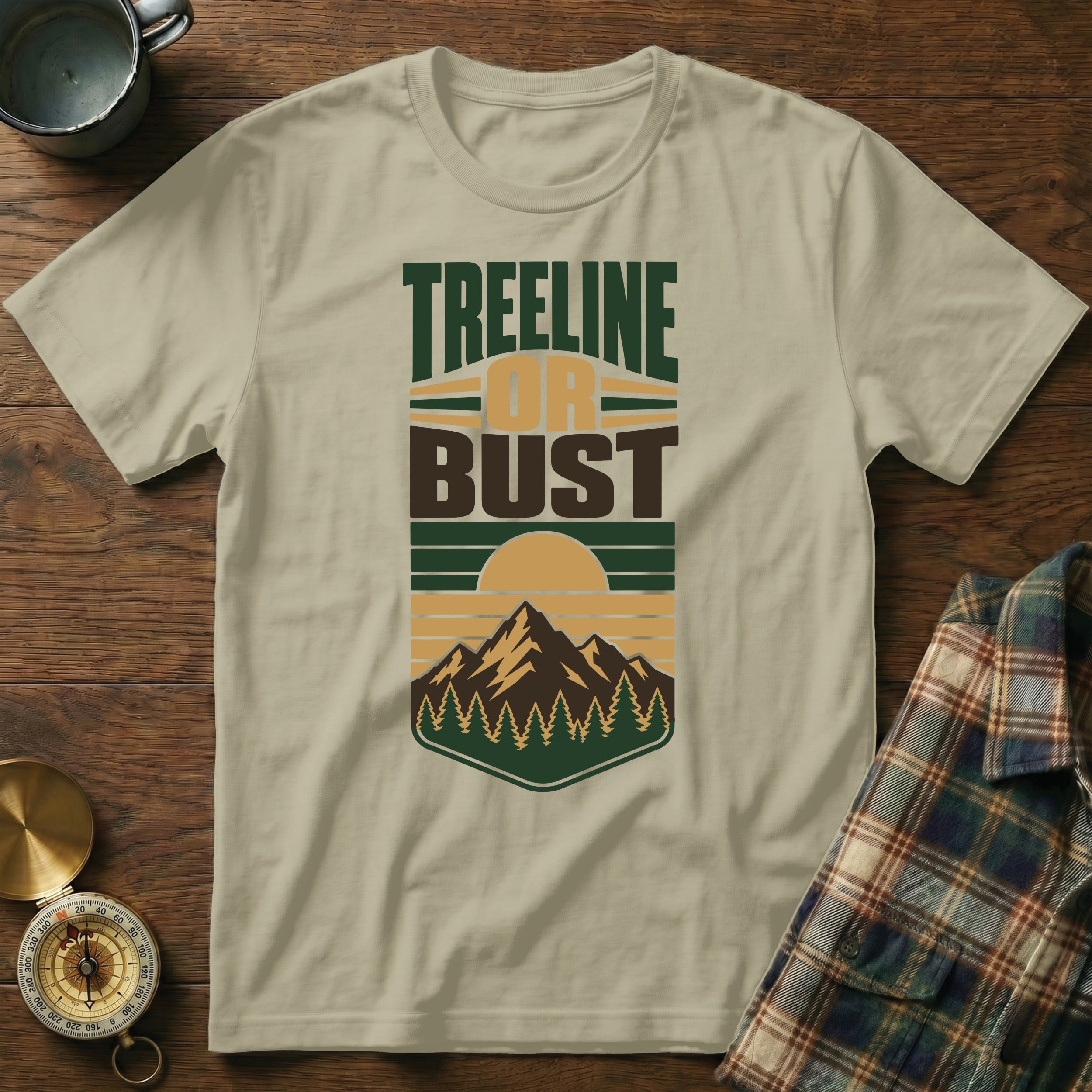 T-shirt with "Treeline or Bust" text and mountain, forest, and sun graphic.
