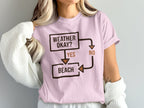 Pink t-shirt with a flowchart about the beach that says "Weather Okay? Yes Beach, No".