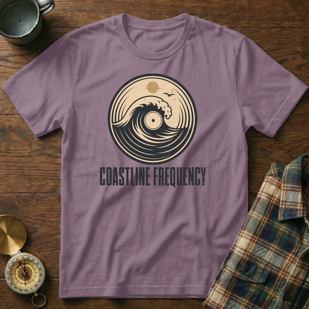 Purple t-shirt with "Coastline Frequency" and a wave in a vinyl record design.