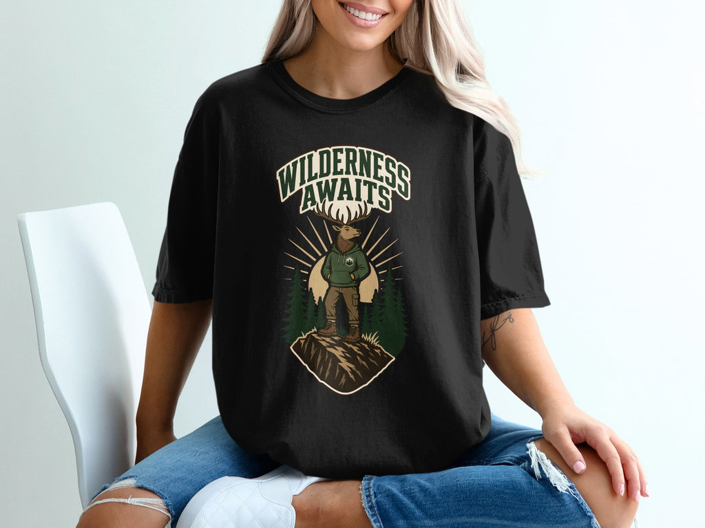Black t-shirt with graphic of elk on mountain, text "WILDERNESS AWAITS".