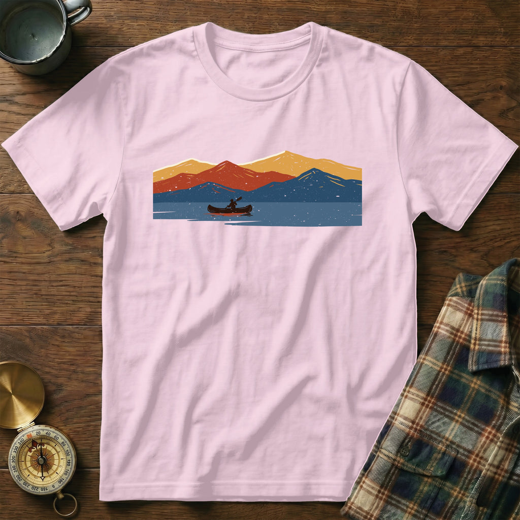 Pink t-shirt with a graphic of a canoeist on a lake with abstract mountains.
