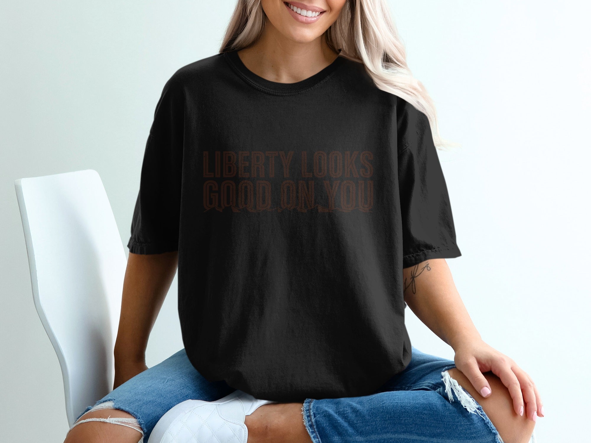 Black t-shirt with "LIBERTY LOOKS GOOD ON YOU" text.