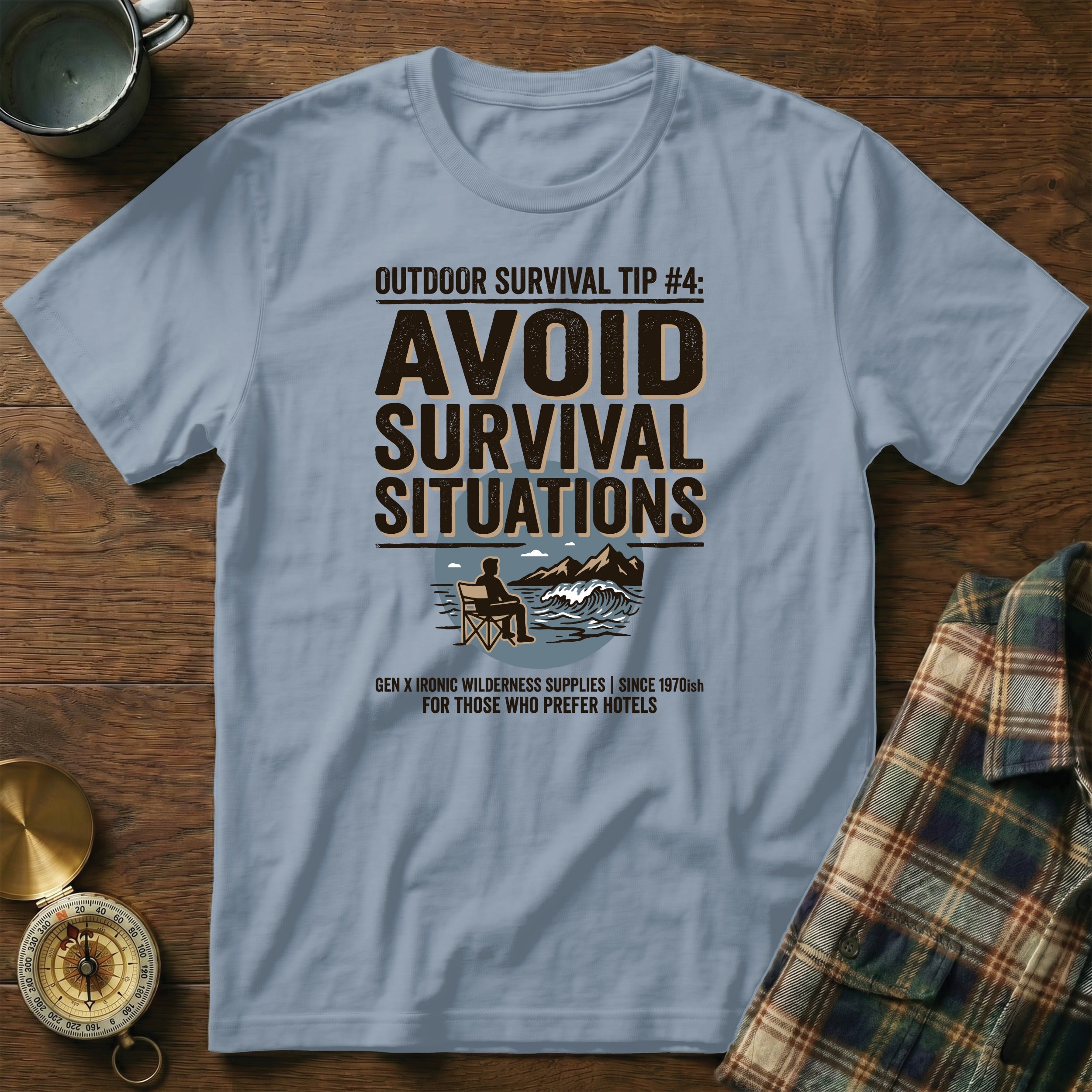 Light blue t-shirt with "Avoid Survival Situations" text and camping graphic.