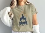 Tan t-shirt with a stylized campfire graphic in navy blue and orange.