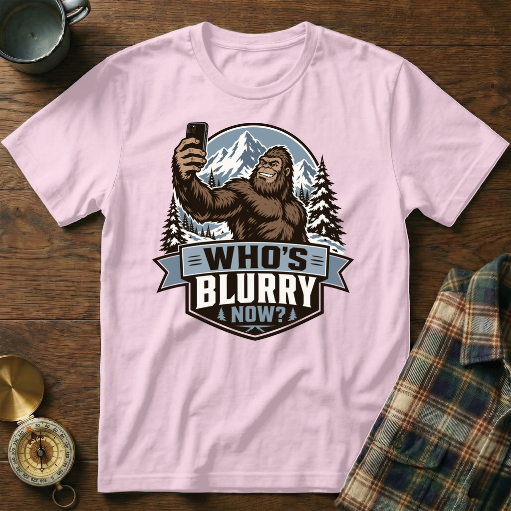 Bigfoot taking a selfie in mountains with text "Who's Blurry Now?".