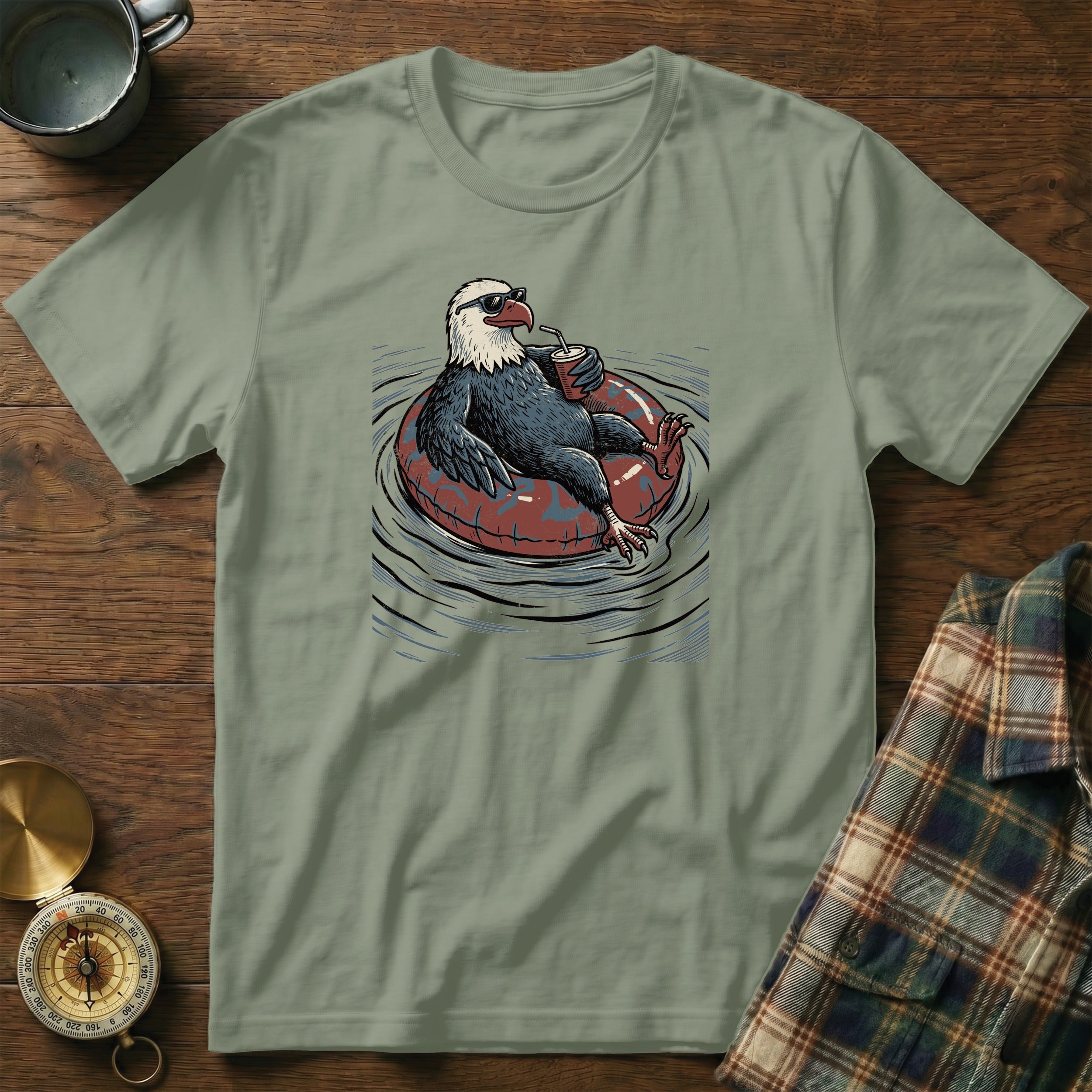 Bald eagle wearing sunglasses on an inner tube, drinking from a cup.
