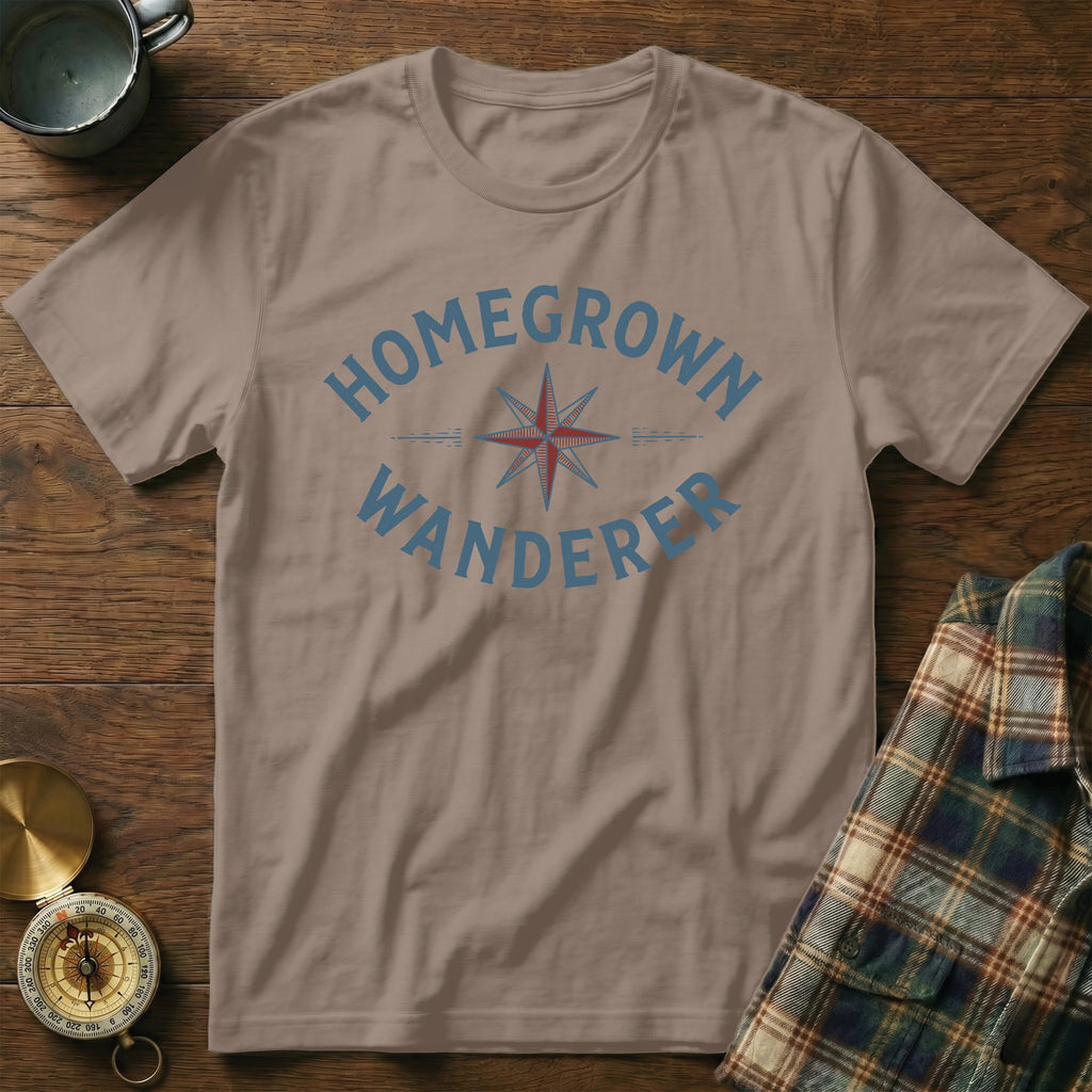Brown t-shirt with blue "HOMEGROWN WANDERER" text and a compass graphic.
