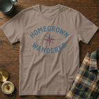 Brown t-shirt with blue "HOMEGROWN WANDERER" text and a compass graphic.