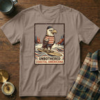 T-shirt with illustration of an eagle surfing and text "UNBOTHERED COASTAL AMERICANA".