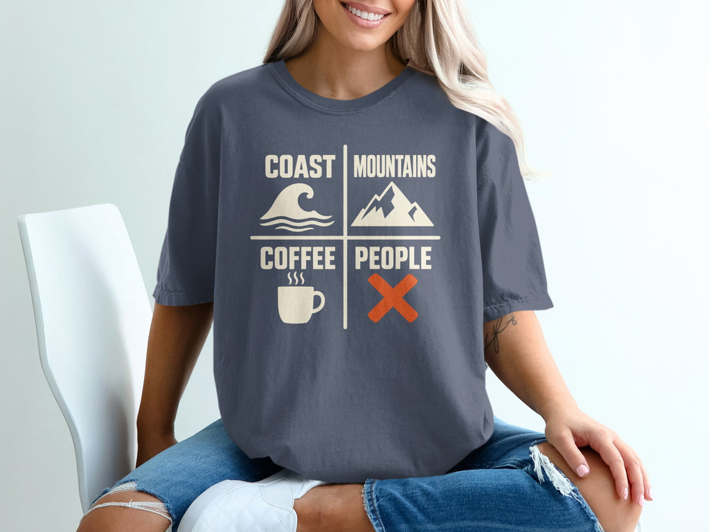T-shirt graphic with text: Coast Mountains Coffee People, wave, mountain, coffee cup, orange X.