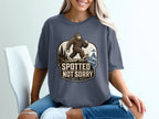 Bigfoot wearing sunglasses walks on a cliff with text "SPOTTED NOT SORRY".