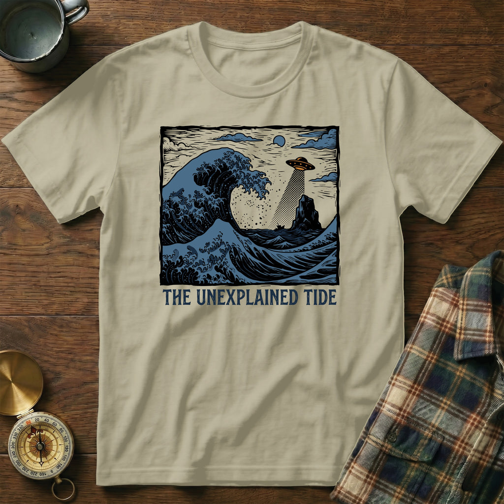 T-shirt with "The Unexplained Tide" text and a wave with a UFO and lighthouse.