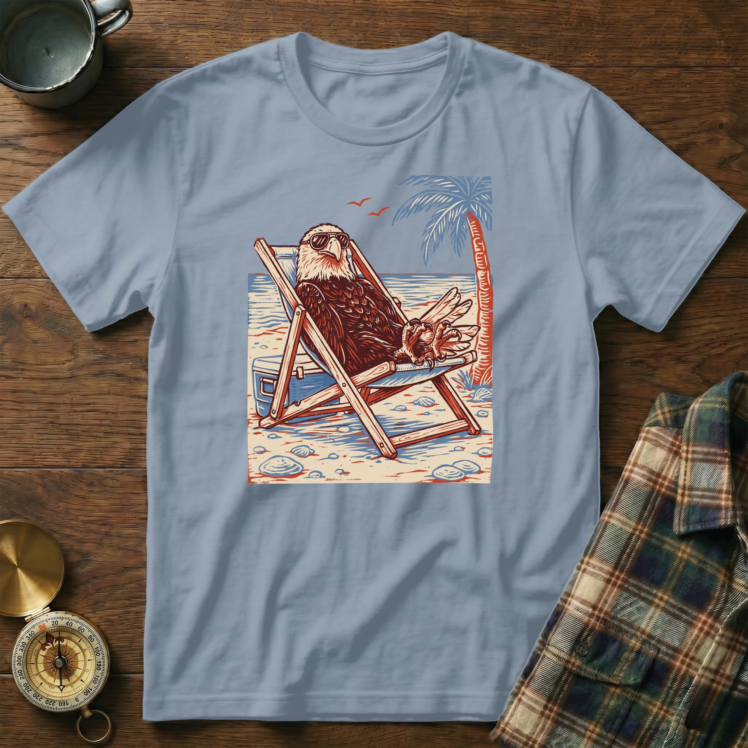 Bald eagle wearing sunglasses relaxing in a beach chair with a palm tree.