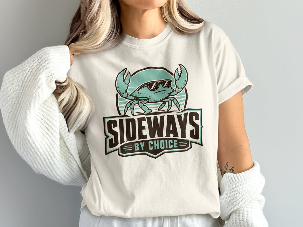 White t-shirt with a teal crab wearing sunglasses and the text "SIDEWAYS BY CHOICE".