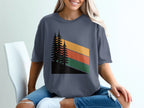 Dark blue t-shirt with abstract tree line and striped sunset graphic.