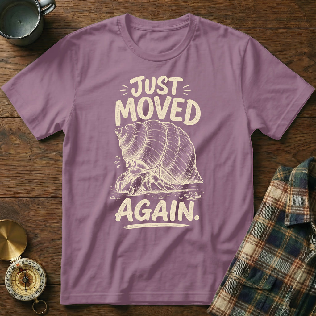 T-shirt with text "JUST MOVED AGAIN" and a hermit crab graphic.