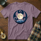 Purple t-shirt with a circular print of a moon over mountains and trees.